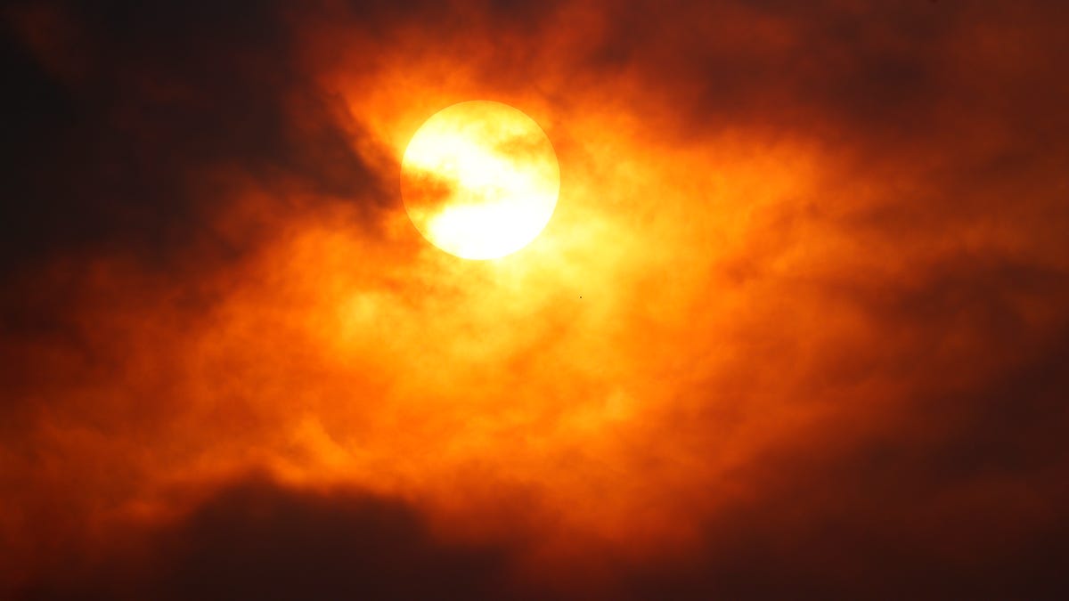 Smoke from several wildfires in Colorado obscures the sun in Denver on Friday, Aug. 14, 2020.