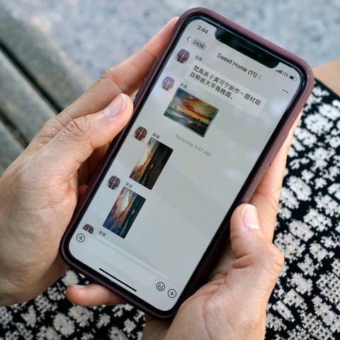 Sha Zhu, of Washington, shows the app WeChat on he