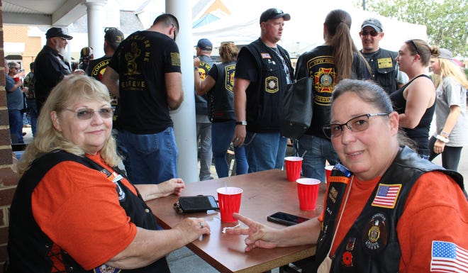 On the left, Mabelle Green of American Legion Post 146 in Hopewell and Katie Lacy of American Legion Post 2 of Petersburg listen for door prize numbers being called after the “Ride for Sierra” dice run at the River’s Bend Grill in Chester on August 8, 2020.