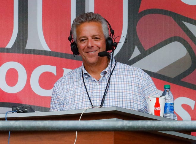 In this Sept. 25, 2019, file photo, Cincinnati Reds broadcaster Thom Brennaman sits in a special outside booth before the Reds' baseball game against the Milwaukee Brewers in Cincinnati.