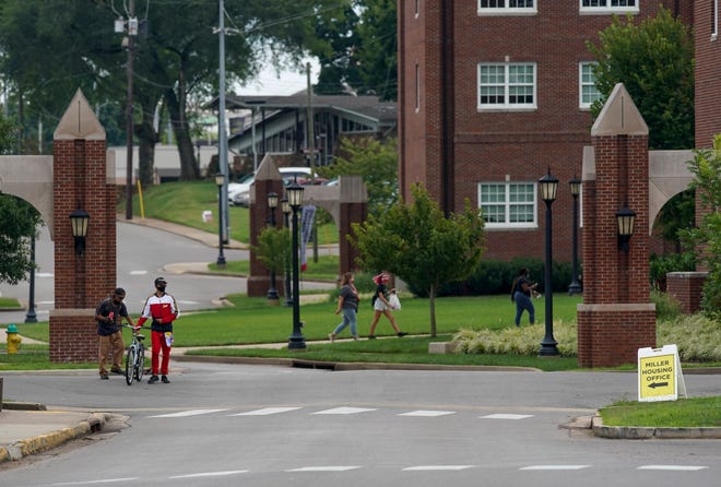 Students and residents walking through campus don masks and pass by scattered at Austin Peay State University in Clarksville, Tenn., on Wednesday, Aug. 19, 2020.