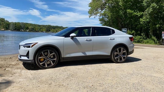 The 2021 Polestar 2 electric car has a long hood and roofline, 4.45-second 0-60 mph acceleration and responsive handling.