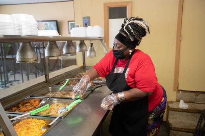 Vanessa Collins, owner of Auntie's Kitchen, prepares her food line for lunch customers Thursday, August 20, 2020. Collin said she's seen a 70% plunge in foot traffic at the South Adams Street soul food restaurant over the last five months.