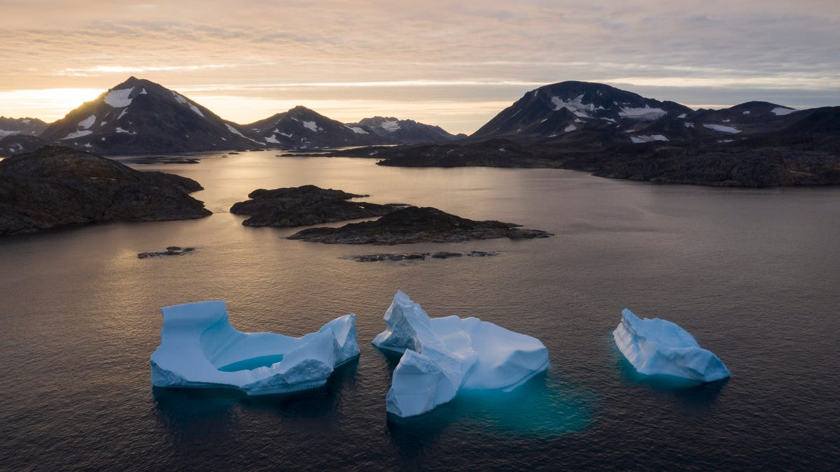 In this Aug. 16, 2019 file photo, icebergs float away as the sun rises near Kulusuk, Greenland. According to a study released on Thursday, Aug. 20, 2020, Greenland lost a record amount of ice during an extra warm 2019, with the melt massive enough to cover California in more than four feet of water.