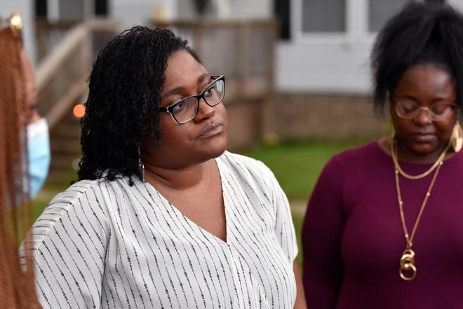 Sabara Fisher-Roberts speaks to reporters during a vigil for her husband, Adrian Jason Roberts, on Thursday evening. [Ed Clemente for The Fayetteville Observer]