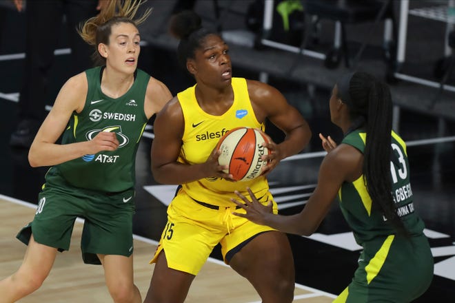 Indiana Fever's Teaira McCowan (!5) drives against the defense of Seattle Storm's Breanna Stewart, left, and Ezi Magbegor during the first half of a WNBA basketball game Thursday, Aug. 20, 2020, in Bradenton, Fla. (AP Photo/Mike Carlson)