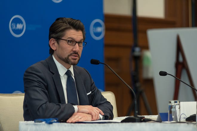 Man speaking a table with microphone