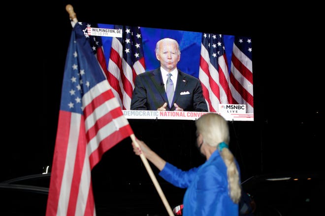 Democratic presidential nominee Joe Biden on a screen at a drive-in theater watch party during the final night of the Democratic National Convention, on Aug. 20, 2020, in Washington.