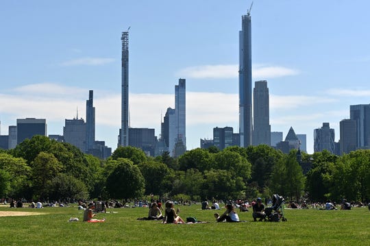 People sit on The Great Lawn in Central Park on Memorial Day during the coronavirus pandemic on May 25, 2020 in New York City.