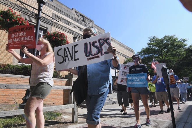 Postal service supporters rally outside the Royal Oak Post Office on Saturday, August 22, 2020.