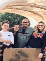 Todd Kunis, 52, who resides in Murrieta, California, pictured with three of his daughters.