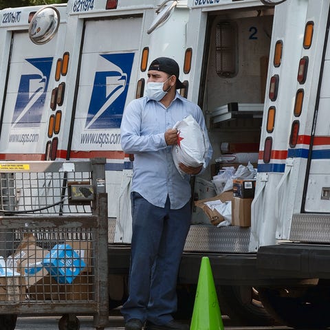 Postal workers are pictured loading packages in th