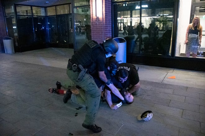 Multiple police officers arrest Detroit resident Kevin Kwart near his apartment lobby in downtown Detroit in the early morning hours on August 23, 2020.