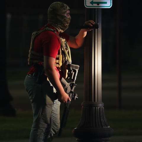 An armed man is seen outside the Kenosha County Co