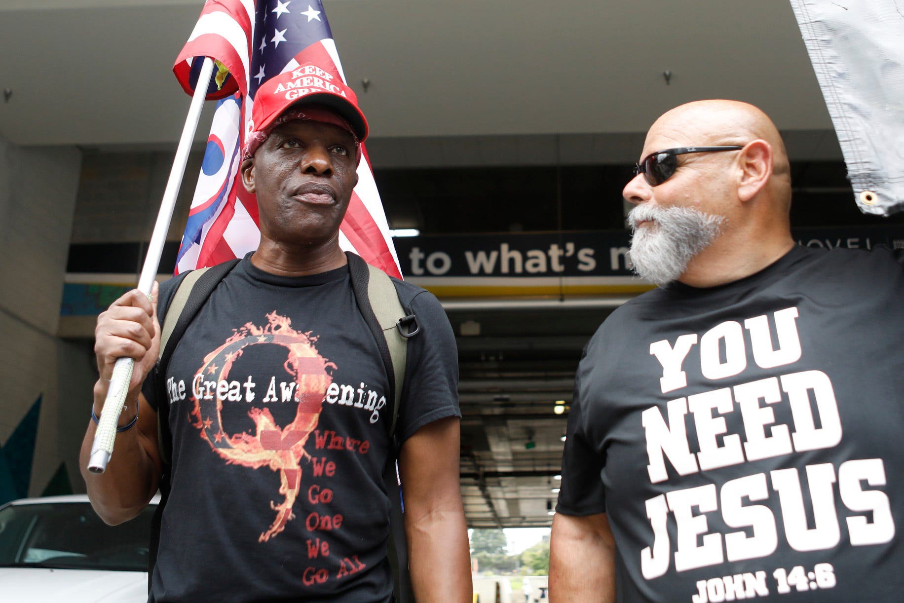 Ken Lane, a supporter of President Donald Trump and QAnon (L), and Ruben Israel of Bible Believers talk about their political beliefs near the Republican National Convention in Uptown on August 24, 2020 in Charlotte, North Carolina.