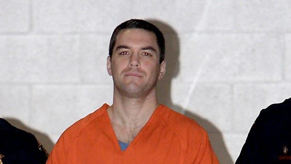 Scott Peterson is escorted by two San Mateo County