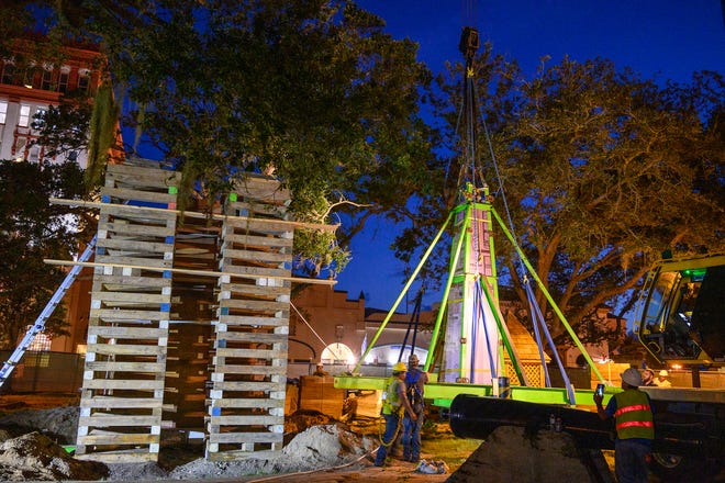 Workers remove the top of St. Augustine's Confederate memorial from the Plaza de la Constitucion before dawn on Wednesday.