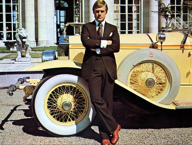 Robert Redford leans on the 1928 Rolls-Royce 40/50 HP Phantom I Ascot Dual Cowl Sport Phaeton, which he drove in the 1974 film "The Great Gatsby." The car will be auctioned online by Classic Promenade Auctions starting Oct. 12.