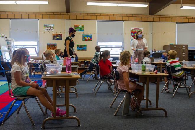 Students watch as kindergarten teacher Mrs. Londa Hart delivers instructions on the first day of school at Chief Joseph Elementary School on Wednesday, Aug. 26, 2020. Desks were separated in classrooms in an effort to maintain social distancing between students, however because six feet of space cannot be maintained in the classroom students are required to wear masks.