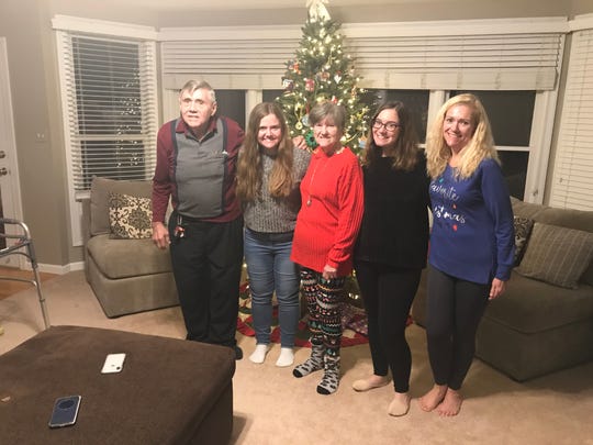 Charles Pyles (far right) with his wife (center), daughter (far left) and grandkids at a Christmas celebration.