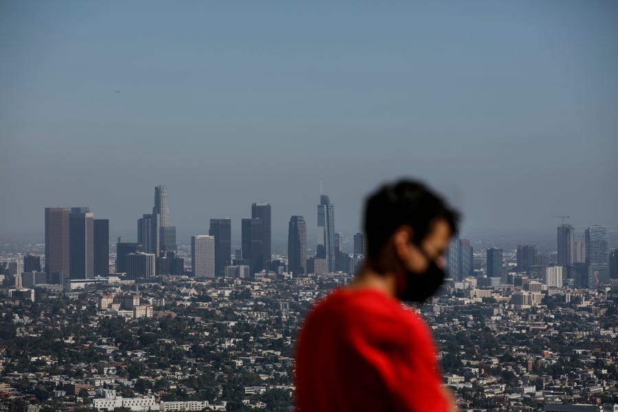Izzy Galvan, 20, wears a face mask while visiting the Griffith Observatory overlooking downtown Los Angeles, in July.