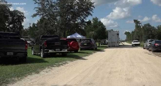Putnam County investigators work the double homicide of 12- and 14-year-old brothers on Wednesday in a quiet Melrose neighborhood.