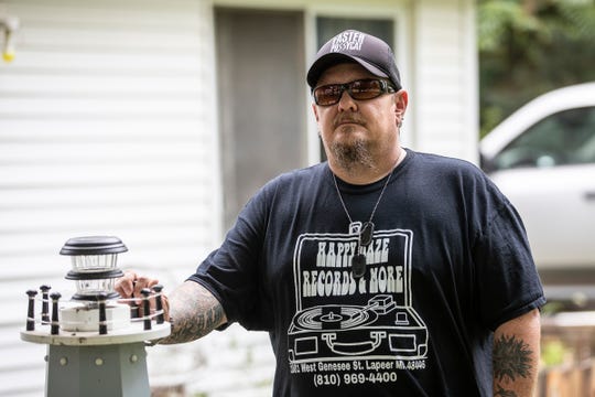 Dennis Williams poses for a photo in front of his home in Lapeer, Thursday, August 27, 2020.