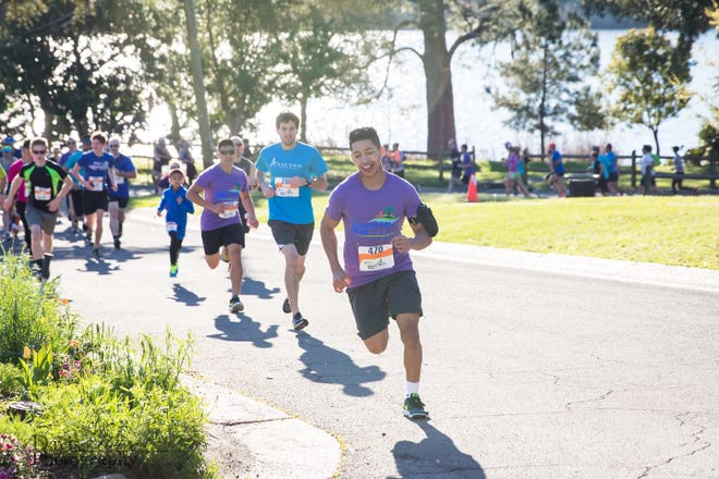 Runners participate in the Bayou  Hills Run along Bayou Texar in an undated photo. The Bayou Hills Run is taking a virtual form in 2020 in reaction to the COVID-19 pandemic.