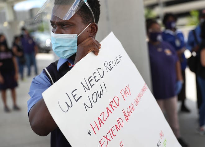 Jean Benjamin joins unemployed airport workers, the Black Lives Matter Alliance of Broward and other supporters to ask that Delta Airlines contractor Eulen America, which demonstrators say received $25 million in federal coronavirus relief, hire back unemployed Fort Lauderdale-Hollywood International Airport workers on Aug. 13 in Fort Lauderdale, Fla.