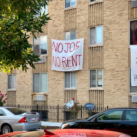 Banners against renters eviction reading no job, n