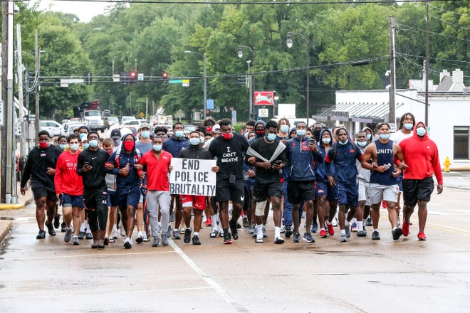 Ole Miss Football players marched from The Manning Center on the Ole Miss Campus to the Oxford Square on August 28th, 2020 in Oxford, MS. Photo By Joshua McCoy/Ole Miss AthleticsInstagram and Twitter: @OleMissPixBuy Photos at RebelWallArt.com