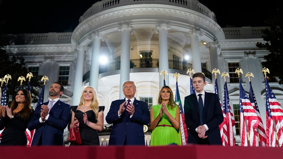 From left, Kimberly Guilfoyle, Donald Trump Jr., Tiffany Trump, President Donald Trump, first lady Melania Trump and Barron Trump stand on the South Lawn of the White House on the fourth day of the Republican National Convention, Thursday, Aug. 27, 2020, in Washington. (AP Photo/Evan Vucci)