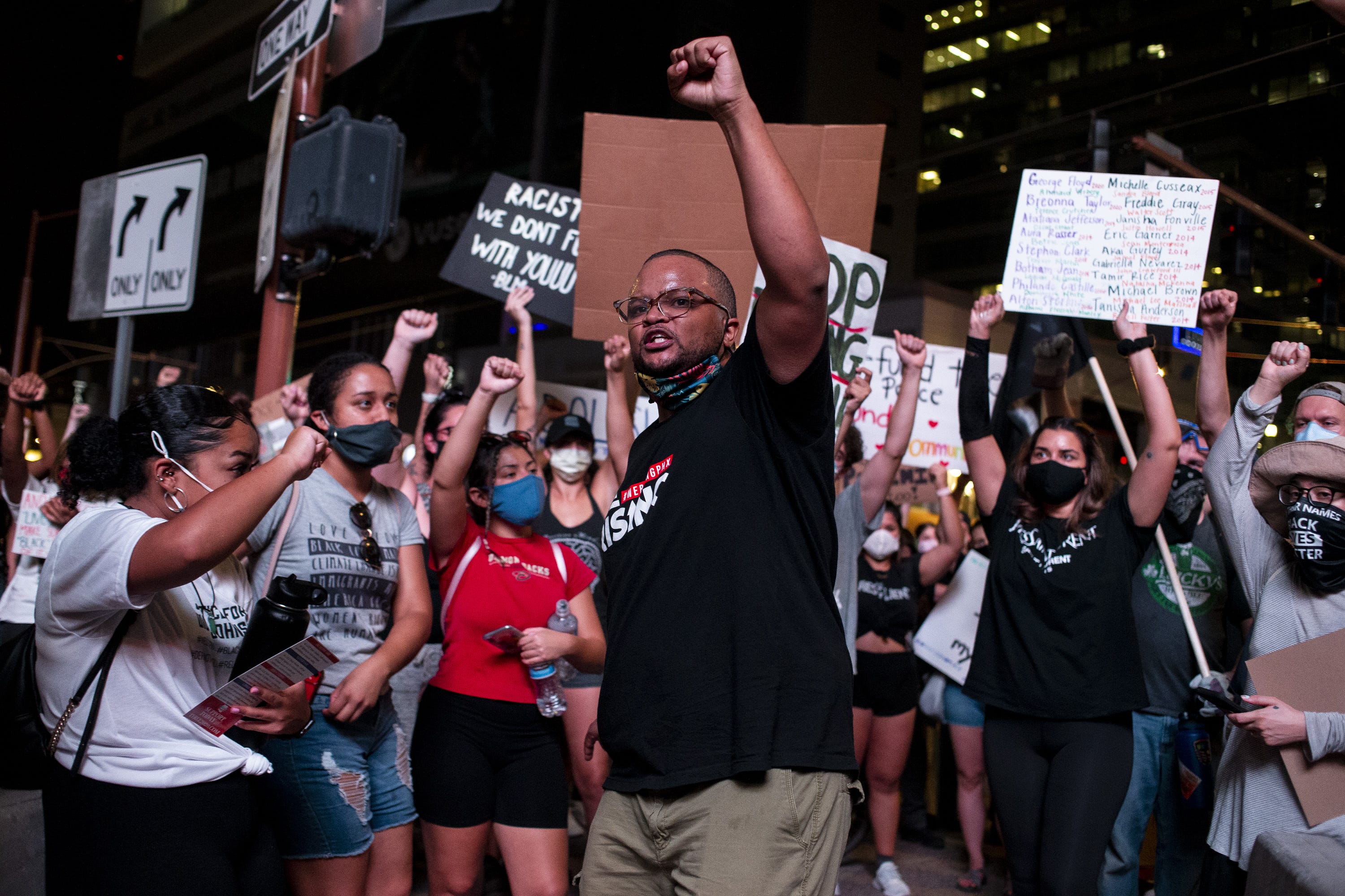 Jacob Raiford raises his fist as he marches on the 57th anniversary of the historic March on Washington on August 28, 2020, in Phoenix.