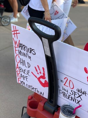A "#WeCare" sign at the "Save the Children" event in Phoenix on Aug. 29, 2020.