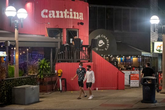 People walk past Cantina Taqueria + Bar along South University Avenue in Ann Arbor, Mich on Aug. 28, 2020.