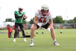 Cole Bentley blocks after hiking the ball in practice during fall camp.