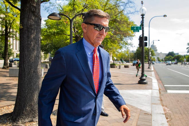 FILE - In this Sept. 10, 2019 file photo, Michael Flynn, President Donald Trump's former national security adviser, leaves the federal court following a status conference in Washington. The arrest of President Donald Trumpâ€™s former chief strategist Steve Bannon adds to a growing list of Trump associates ensnared in legal trouble. They include the president's former campaign chair, Paul Manafort, whom Bannon replaced, his longtime lawyer, Michael Cohen, and his former national security adviser, Michael Flynn.  (AP Photo/Manuel Balce Ceneta, File)