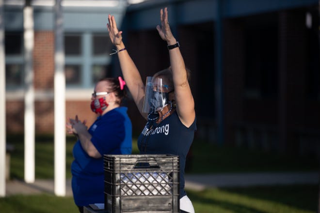 Fort Braden School teachers give a warm welcome to students arriving by bus on the first day of school Monday, August 31, 2020. 