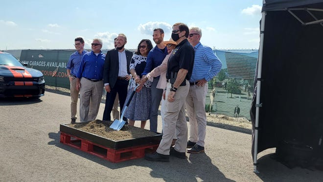 A who's who of Oakland County dignitaries joined M1 CEO Jordan Zlotoff (sixth from left) for the groundbreaking of the M1 Concourse Event Center including Sheriff Mike Bouchard (black mask), Executive David Coulter (fourth from left), and Pontiac Mayor Dierdre Waterman (fifthe from left). 