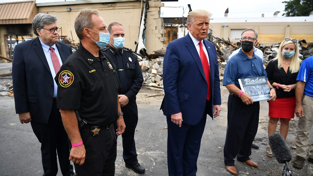 President Donald Trump and Attorney General William Barr tour an area affected by civil unrest in Kenosha, Wis., on Sept. 1.