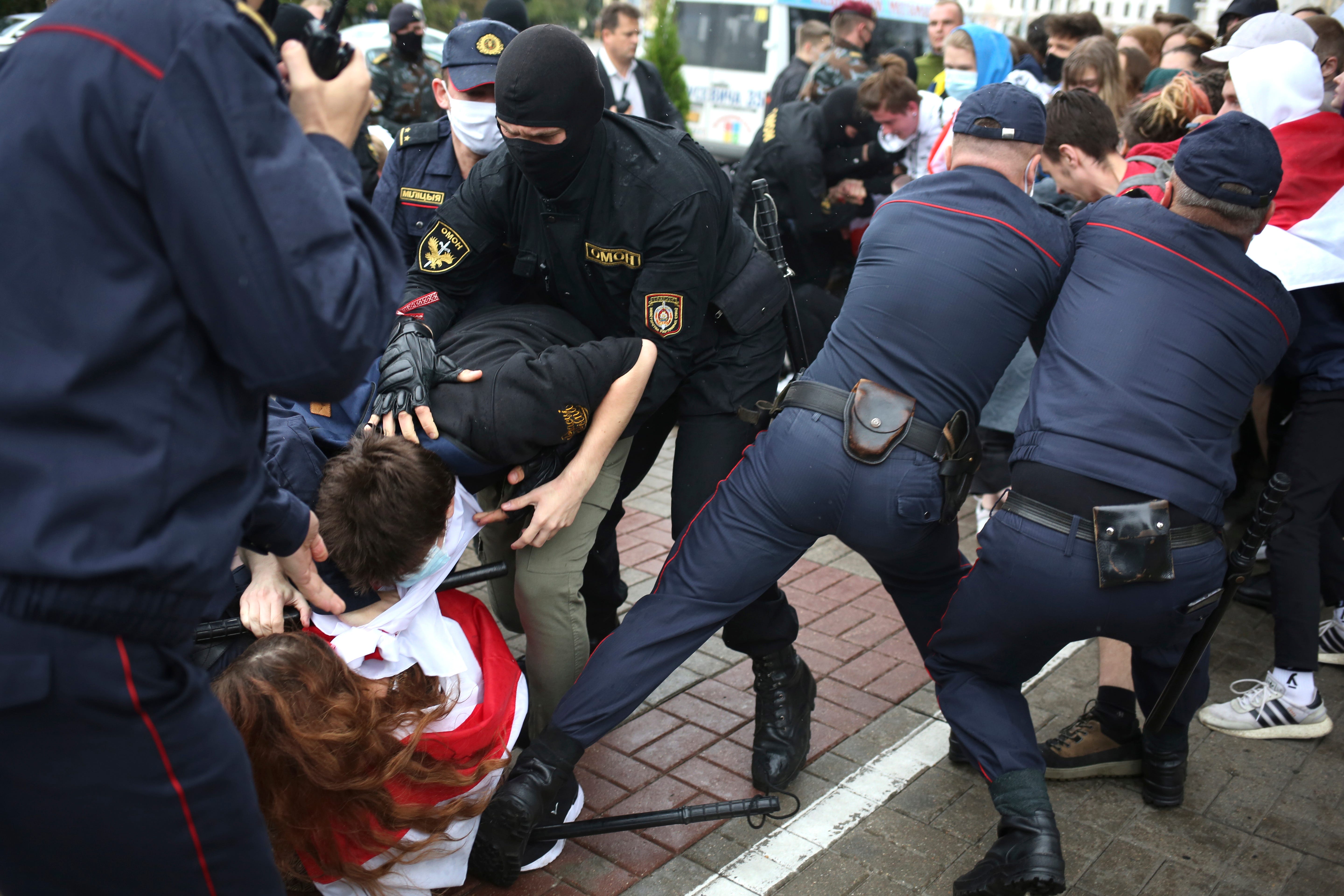 Police detain students during a protest in Minsk, Belarus, on Sept. 1, 2020. Several hundred students gathered in Minsk and marched through the city center, demanding the resignation of the country's authoritarian leader after an election the opposition denounced as rigged. Many have been detained as police moved to break up the crowds.