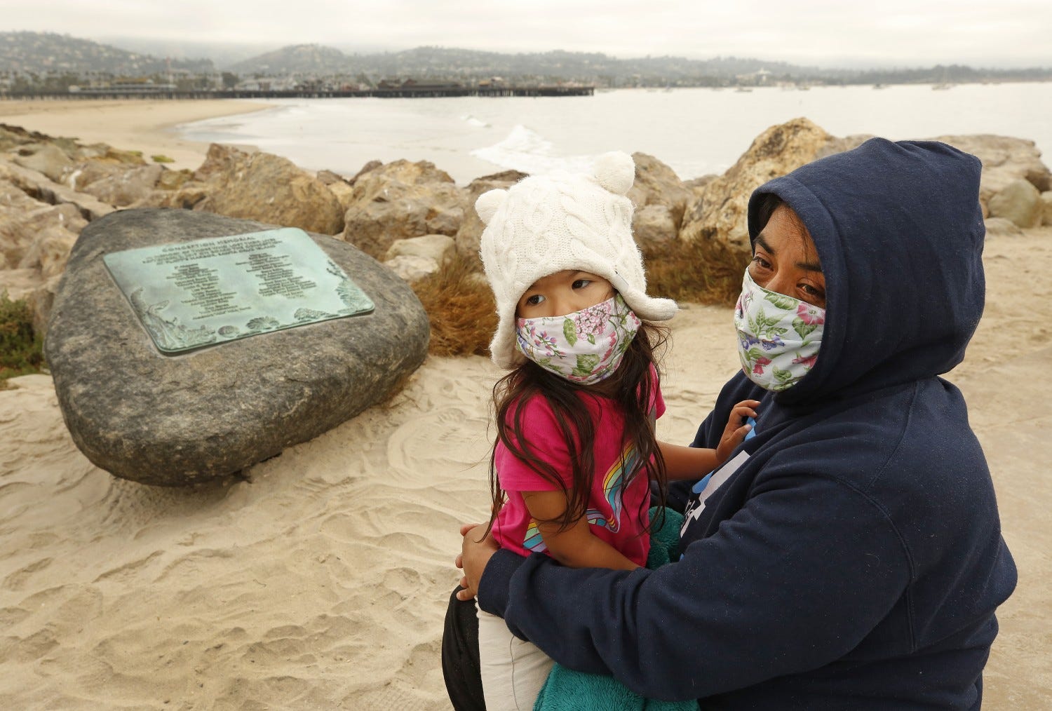 Yadira Alvarez-Peterson holds her 3-year-old daughter Renata Alvarez-Peterson close talking about her 16-year-old daughter Berenice Felipe, who was one of the 34 people who died in the Conception Boat fire one year ago today as family members with friends and officials gathered at Point Castillo at the end of Harbor Walk in the Santa Barbara Harbor where a plaque on a boulder was unveiled to memorialize the 34 lives lost in the Conception Diving Boat fire off Santa Cruz Island on the one year anniversary.