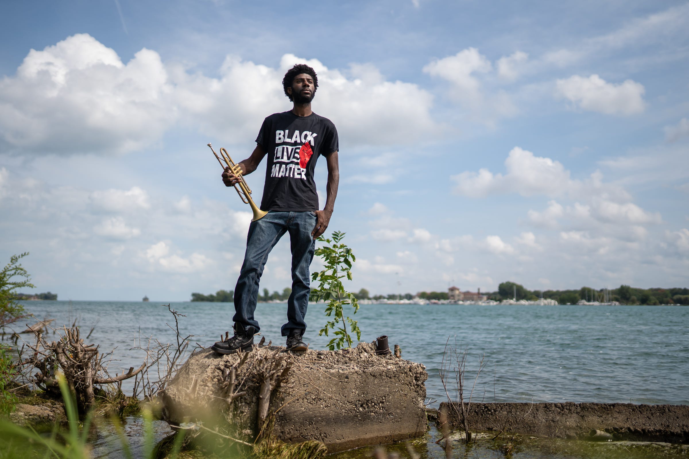 Detroit Will Breathe member Allen Dennard, 26, of Detroit poses for a photo along the Detroit River on Tuesday, September 1, 2020. Dennard, who is a traveling musician, plays the trumpet for protesters as they march through the streets of Detroit against police brutality.