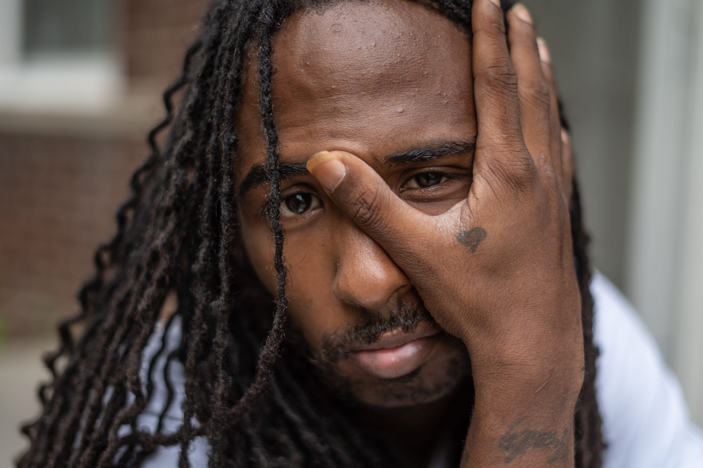 Detroit Will Breathe organizer Darrell "Deez" Flournoy, 29, of Detroit poses for a photo at his home on Detroit's west side on Tuesday, September 1, 2020. Flournoy had a tattoo of a small black heart added in memory of his cousin Trayvon Martin who was fatally shot by George Zimmerman and in memory of his aunt who passed away.