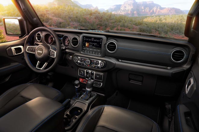 Interior of the 2021 Jeep Wrangler Rubicon 4xe includes Electric Blue accent stitching on seats and interior trim.