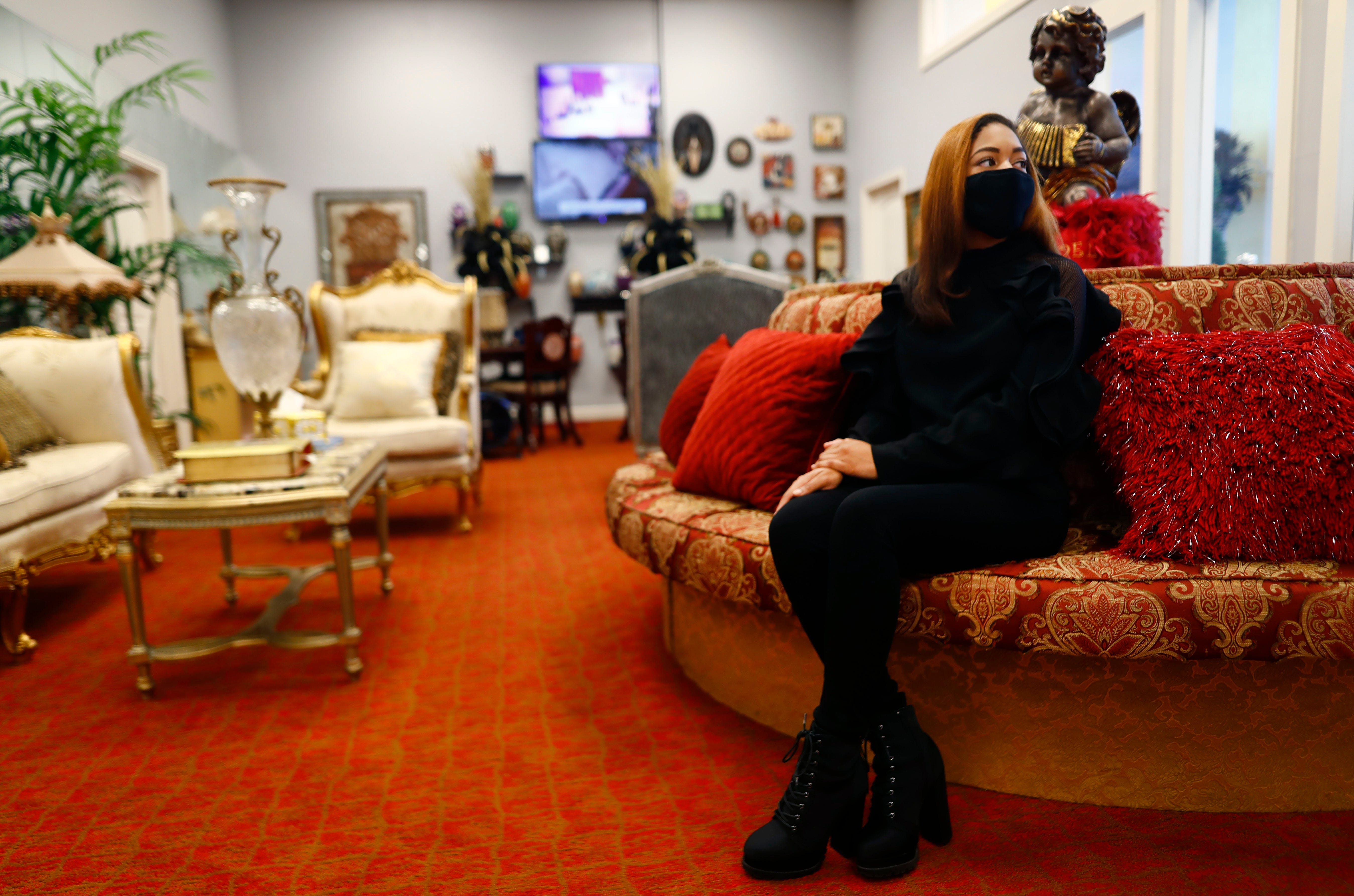 Deja Bernard, daughter of owner Ryan, waits for a family to arrive to discuss celebration of life options inside the family business R Bernard Funeral Services on Sept. 1, 2020.