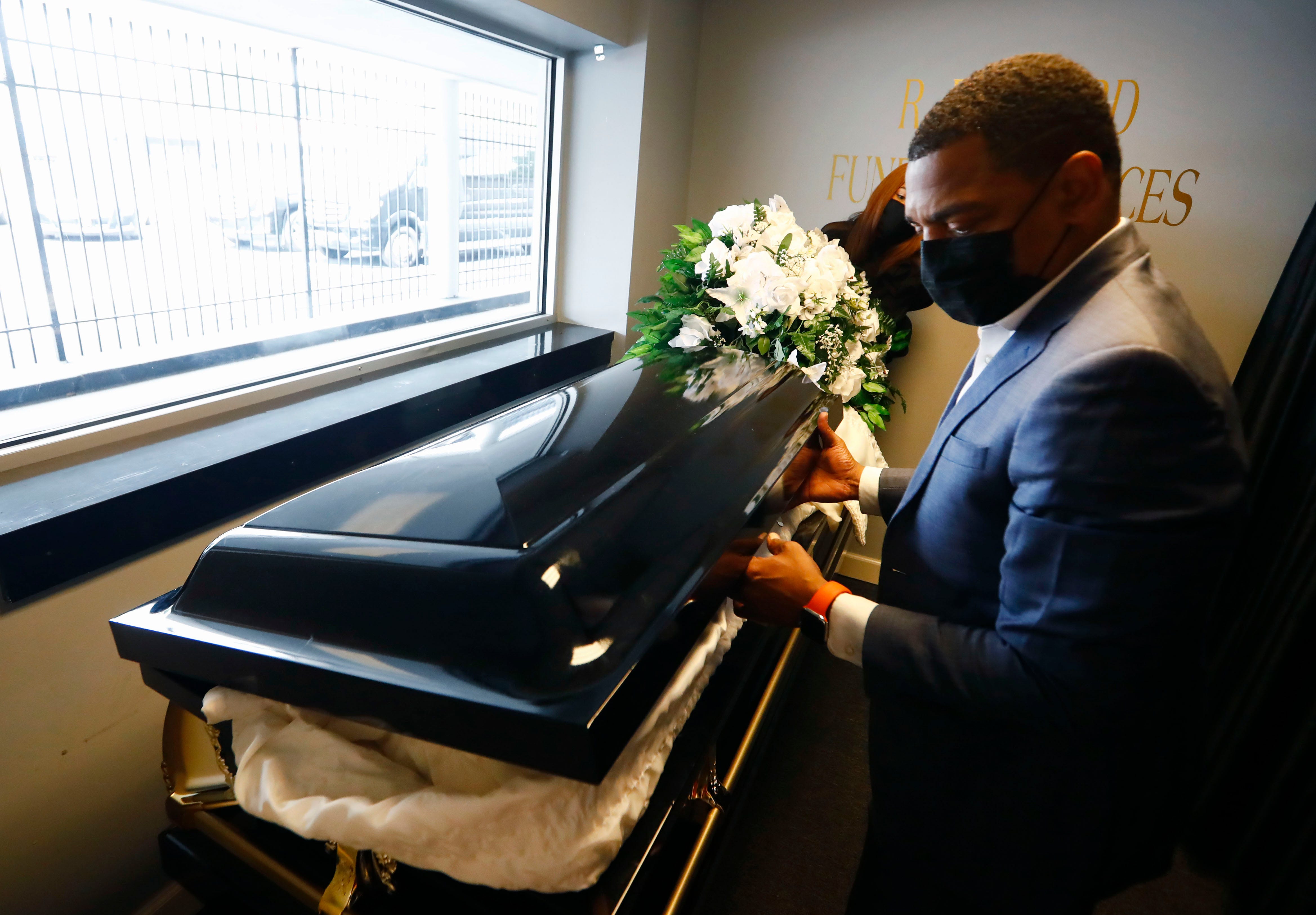 Ryan Bernard moves a casket from the funeral home’s drive-thru viewing window area, which has been utilized extensively during the pandemic for socially distant celebration of life ceremonies at R Bernard Funeral Services on Sept. 1, 2020.