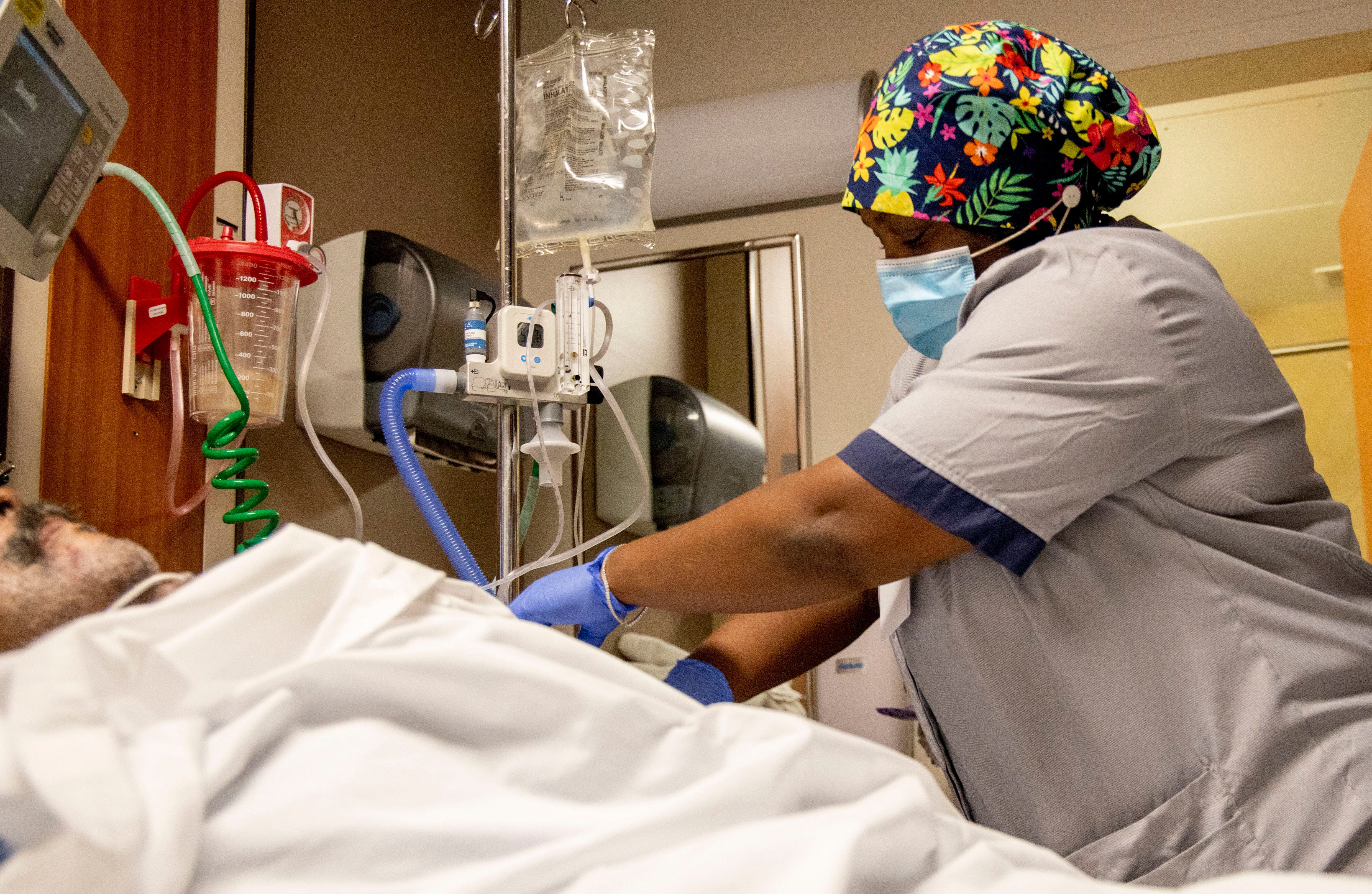 Attendant Keisha Thomas wipes down contact surfaces while cleaning a patient's room Tuesday, Sept. 1, 2020, at Methodist North Hospital in Memphis.