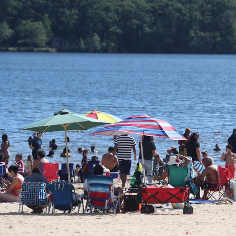 People line the beach at Lake Welch in Harriman St