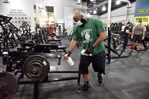 Burnell Franklin, of Paterson, wipes down his workout area at Gold's Gym, which reopened to the public after being closed since March due to the Covid-19 pandemic in Totowa, N.J. on Tuesday Sept. 1, 2020.